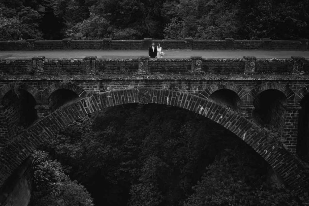 Just-married couple on old bridge