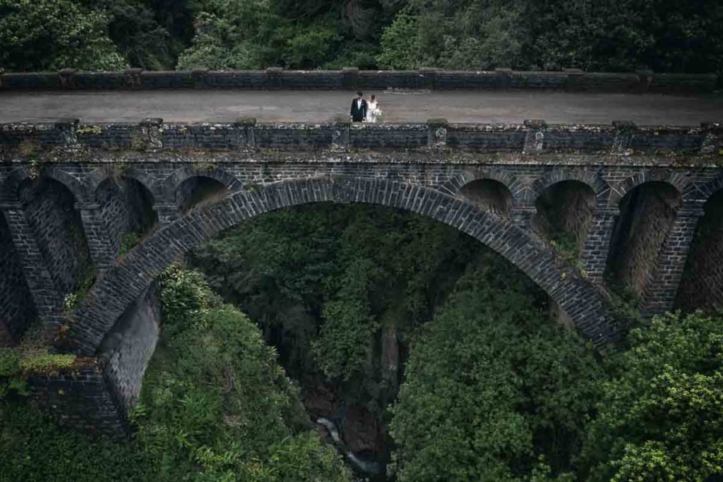 Just-married couple on old bridge