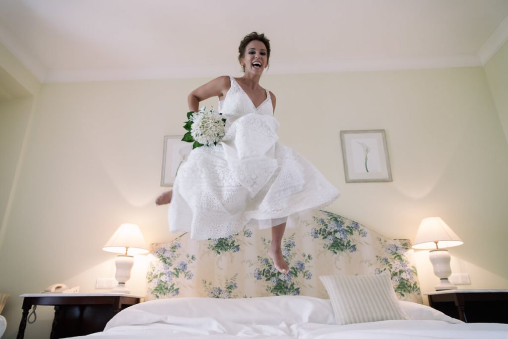 bride with bouquet jumping