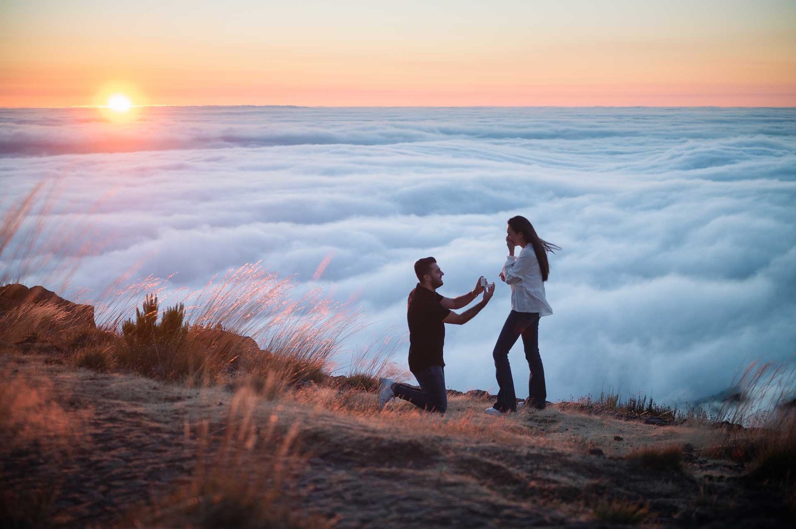 Sunrise marriage proposal above the clouds