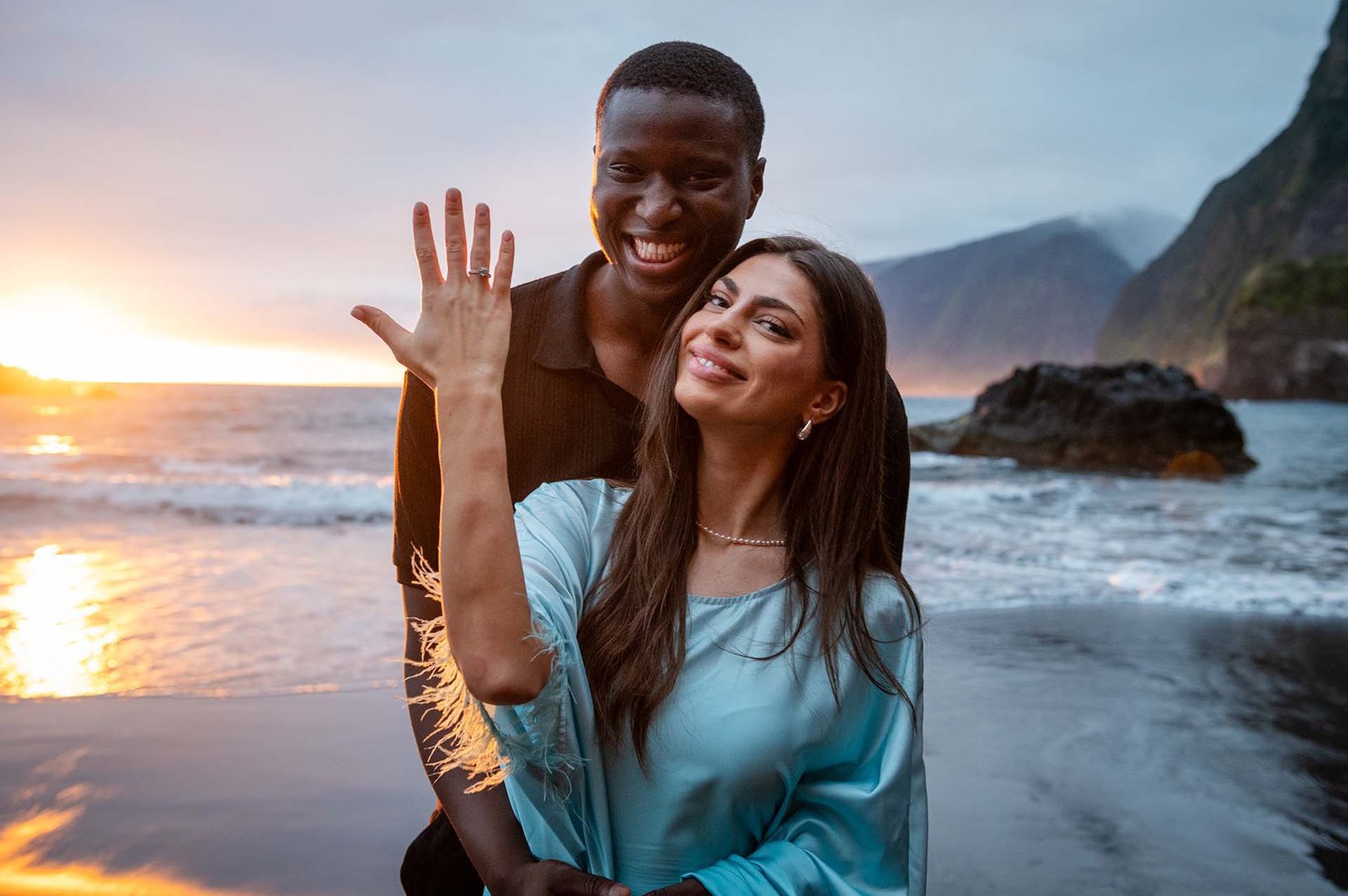 FAQ - Islandpic.com A happy couple after marriage proposal showing the ring